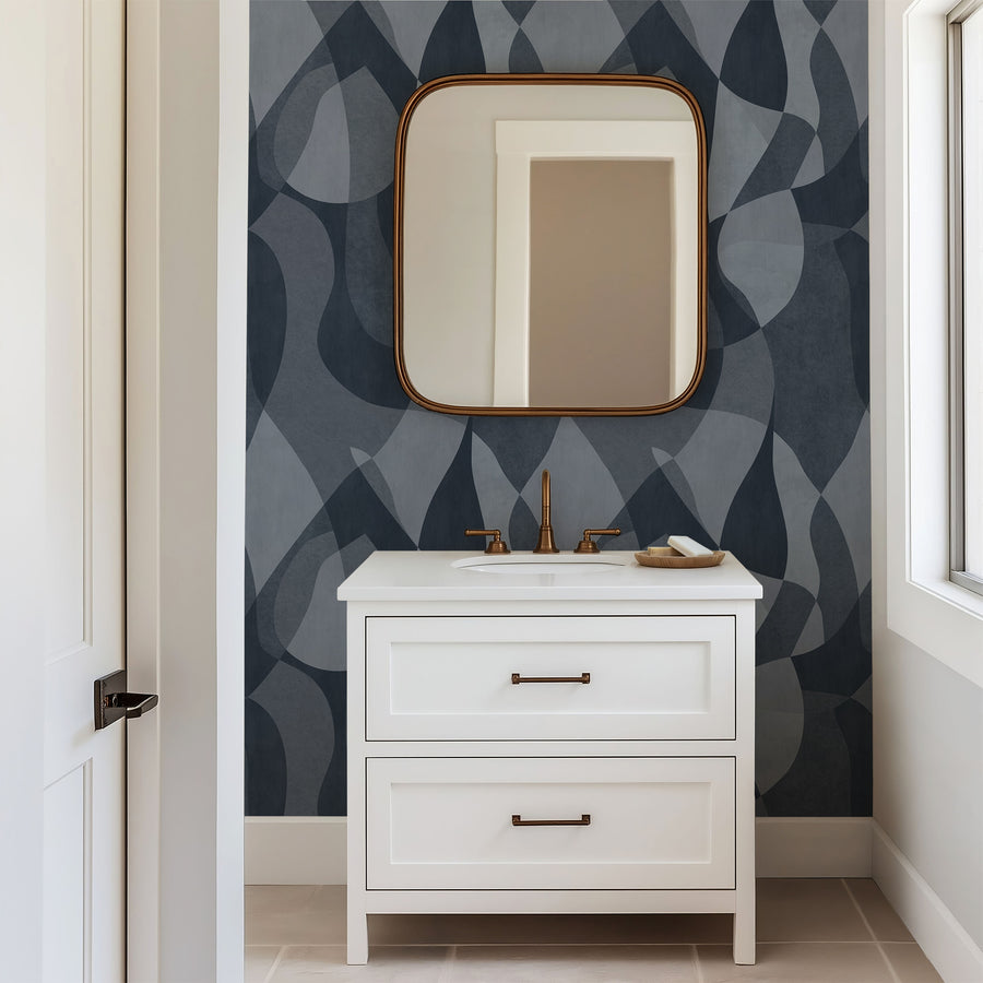Bathroom vanity with mirror against a Mid-Century Abstract Curves Wallpaper – Navy & Slate Blue