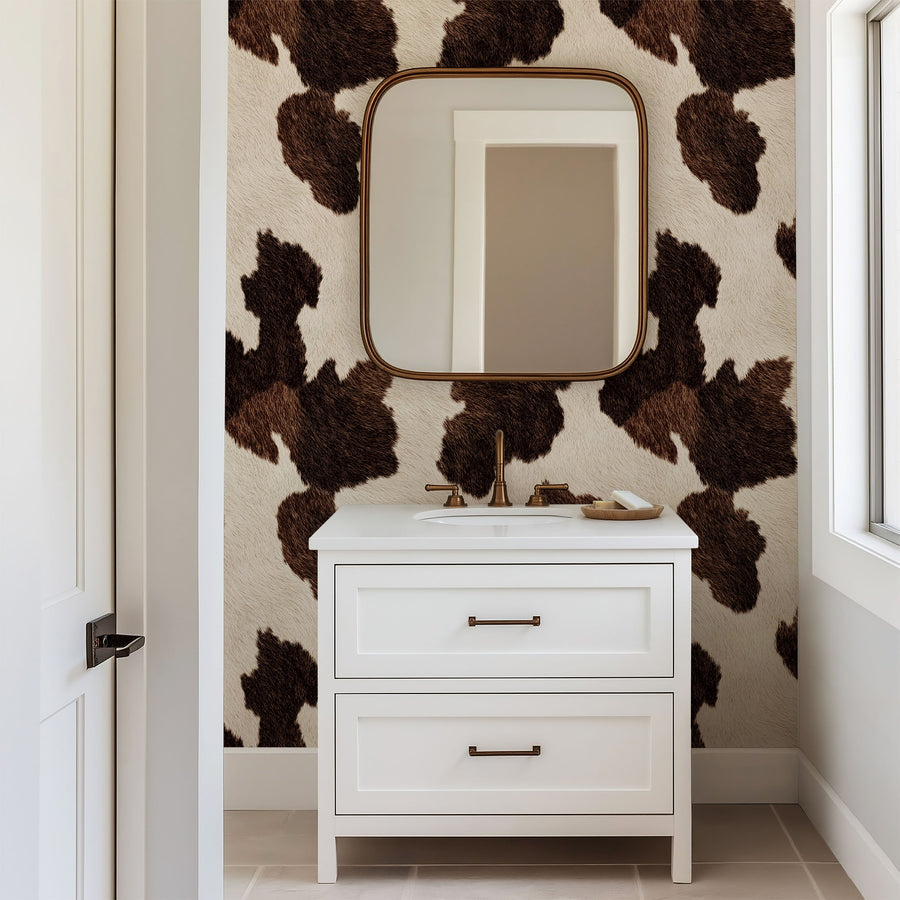 Bathroom vanity with mirror against a wall with Brown Cow Print Wallpaper