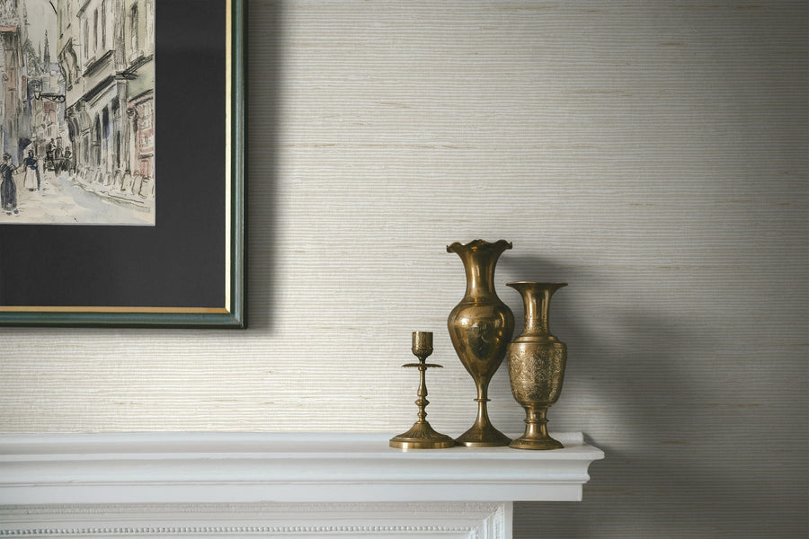 Decorative vases and candlestick on a mantelpiece with a framed picture above.