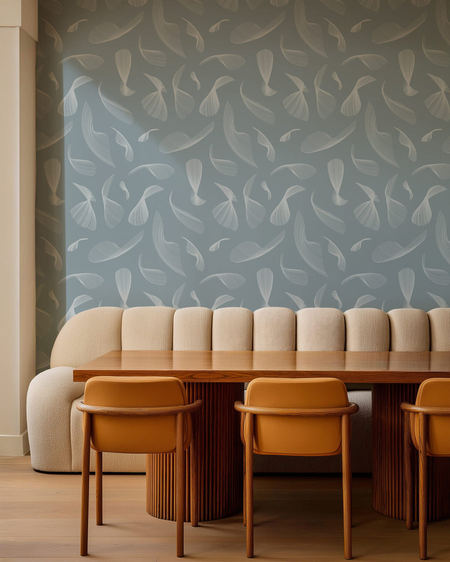 Dining area with a wooden table and chairs against a Quill Whispers Wallpaper – Slate Blue