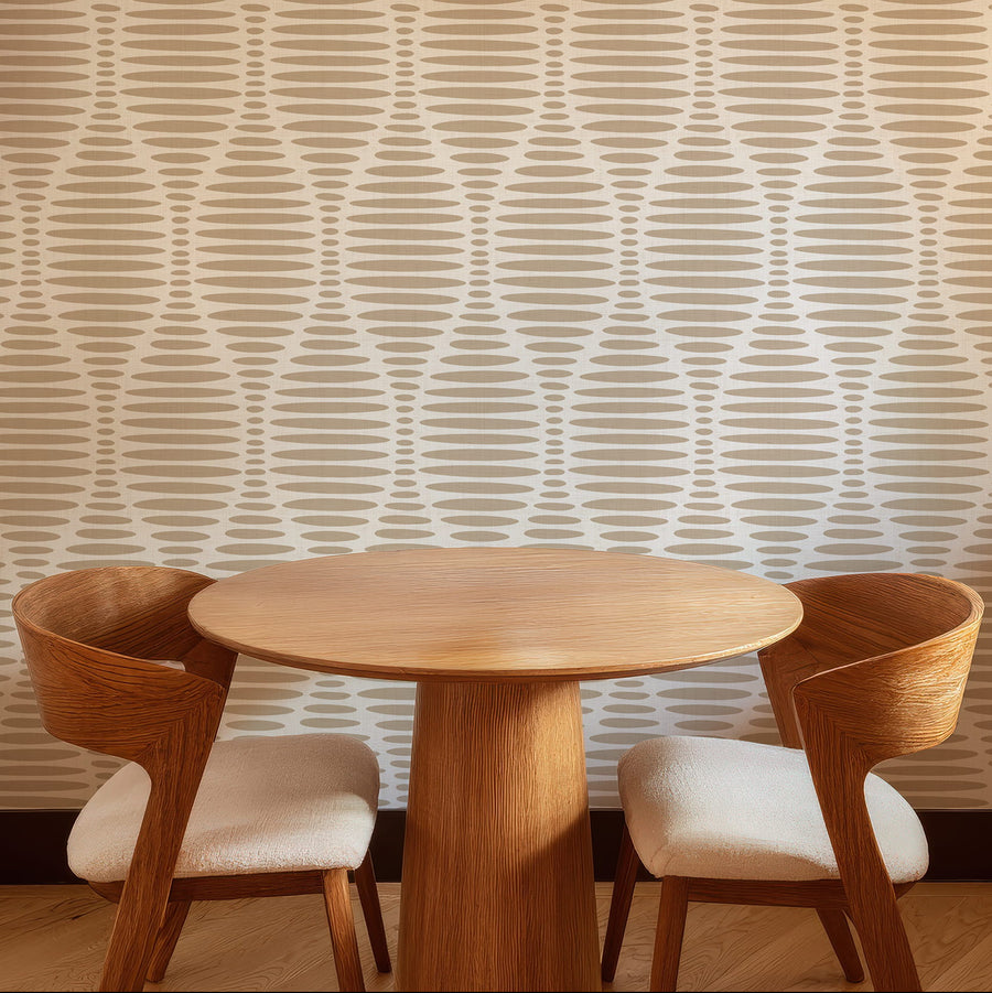 Dining area with wooden table and chairs against a Ogee Sketchy Ovals Wallpaper - Brown & Cream