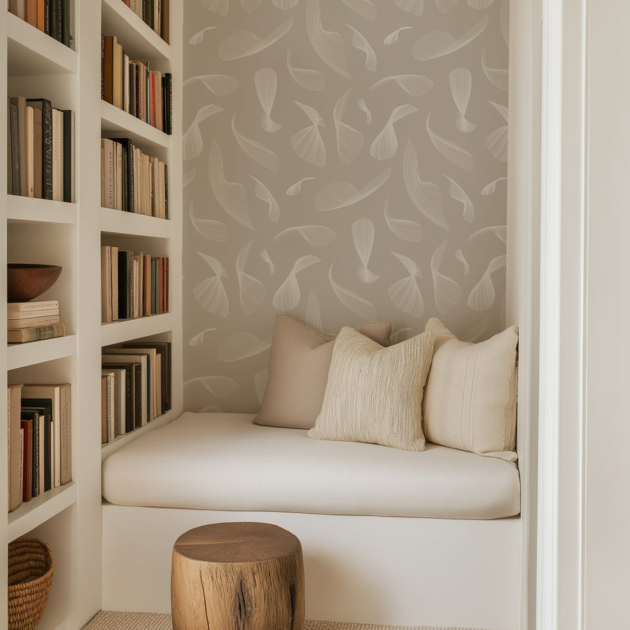 Nook with bookshelf, cushioned seat, and Quill Whispers Wallpaper – Warm Taupe