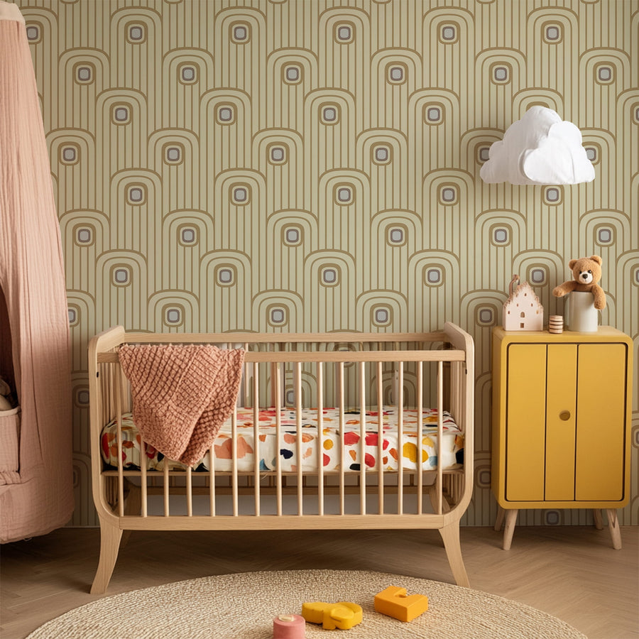 Nursery room with wooden crib, colorful bedding, and yellow cabinet against a Warm Beige 70s Retro Mod Arch Geometric Wallpaper