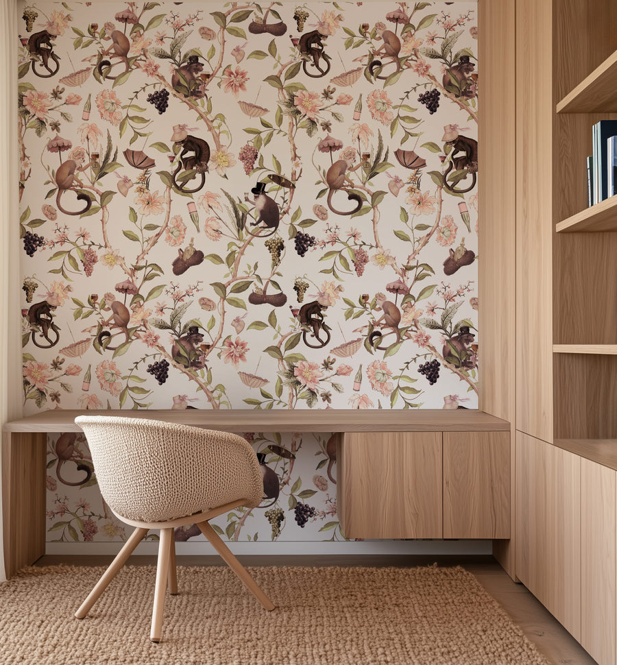 Room interior with Blush Singerie Wallpaper – Romantic Monkey Garden, wooden desk, and chair.