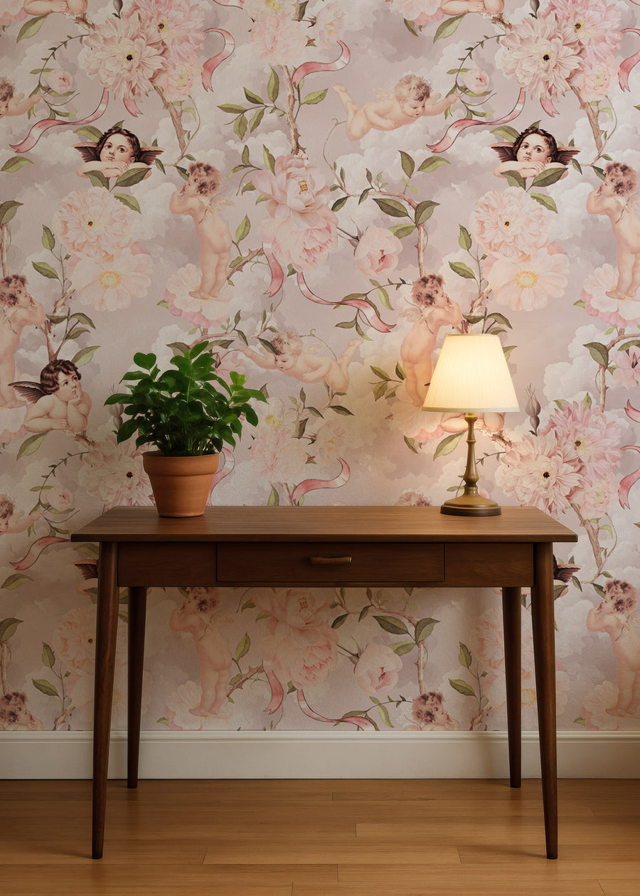 Wooden desk with a lamp and plant against a Pink Cherub Wallpaper – Vintage Peonies & Angels Pattern