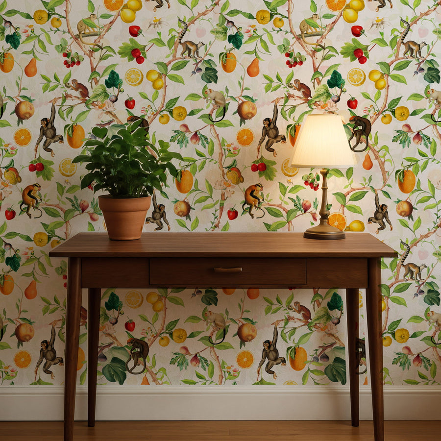 Wooden desk with a lamp and plant against a Tropical Monkey Jungle Wallpaper – Fruit & Botanical Pattern