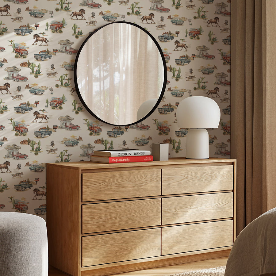 Wooden dresser with round mirror and lamp against a Cream Western Wallpaper