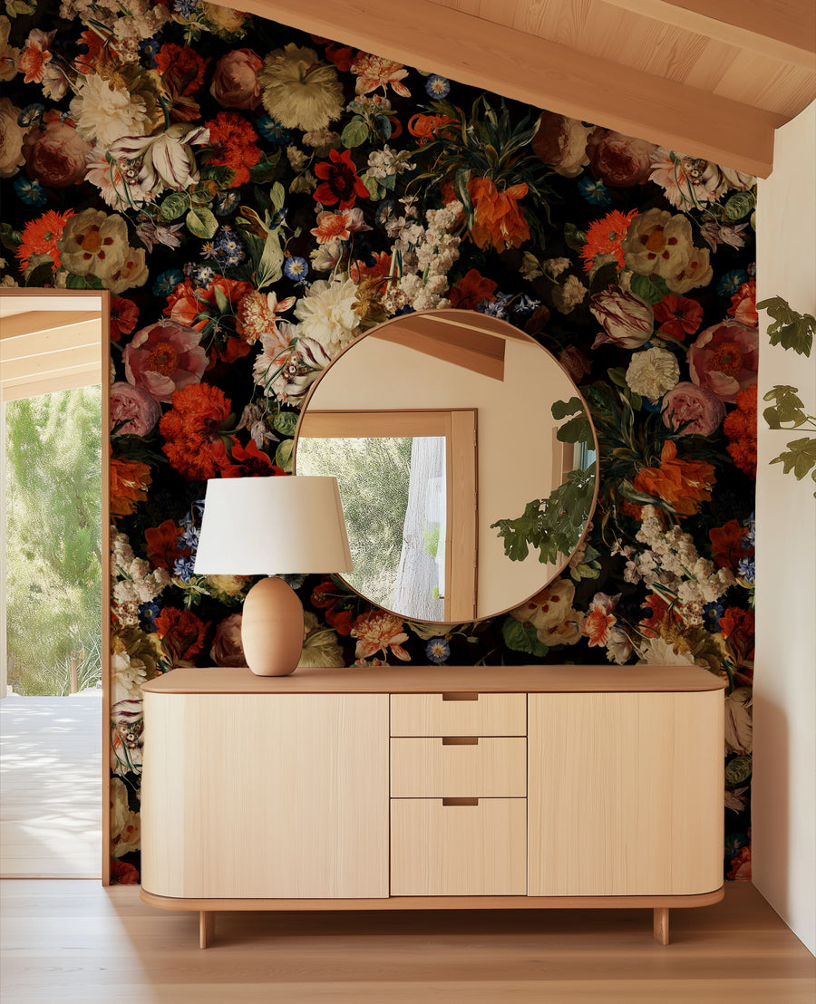 Wooden dresser with round mirror and lamp against a Dark Floral Wallpaper – Moody Dutch Master Bouquet