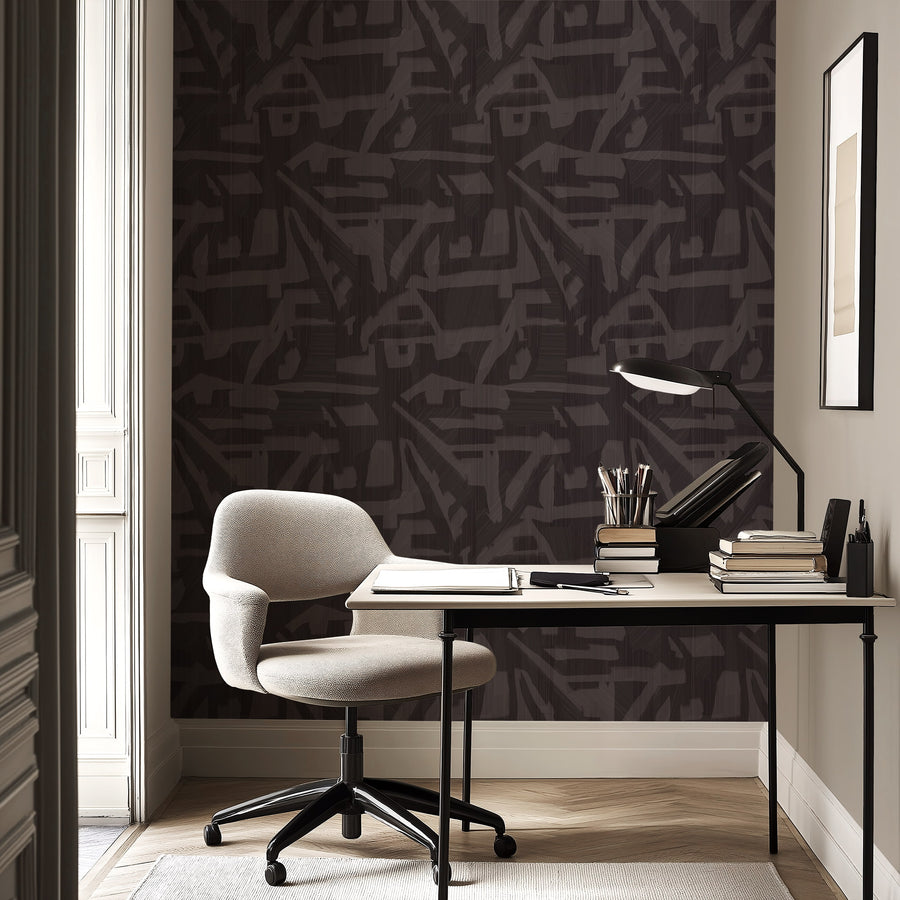 Home office with desk chair and task lamp featuring Abstract Brushstroke Wallpaper Charcoal Grey accent wall
