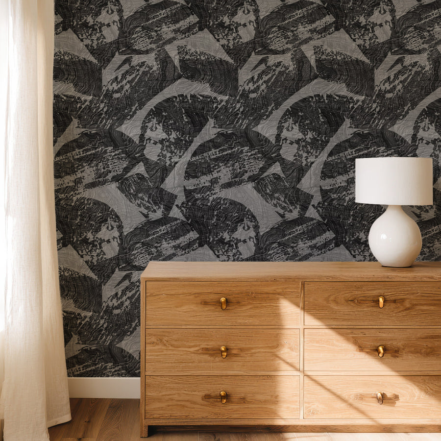 Dresser with white table lamp and framed art featuring Abstract Modern Wood Texture Wallpaper Charcoal Grey accent wall