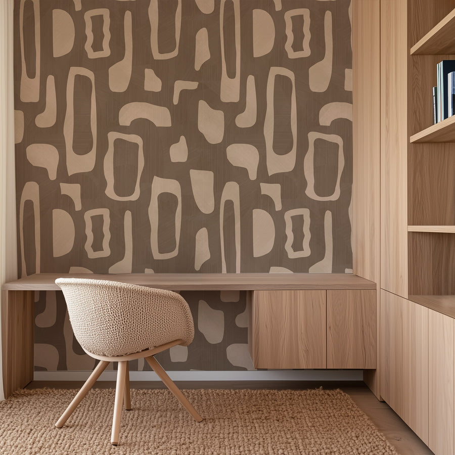 Home office with wood desk cane-back chair and shelving featuring Abstract Organic Shapes Wallpaper Beige Brown accent wall