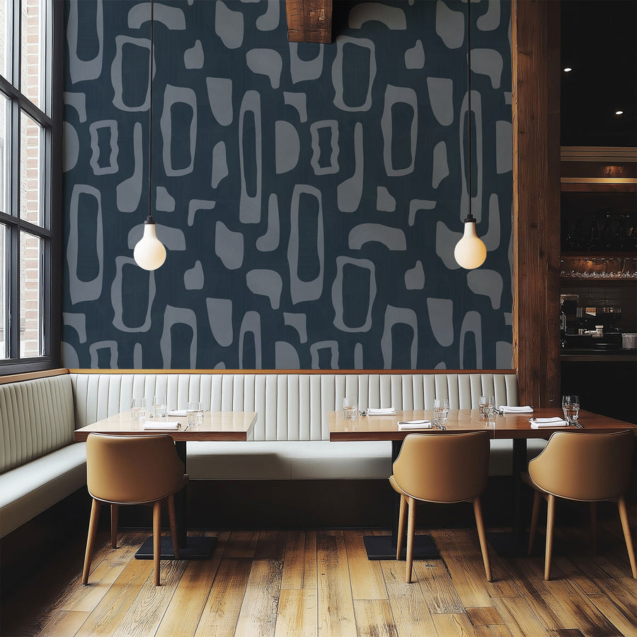 Dining nook with banquette seating and pendant lights featuring Abstract Organic Shapes Wallpaper Navy Slate Blue accent wall