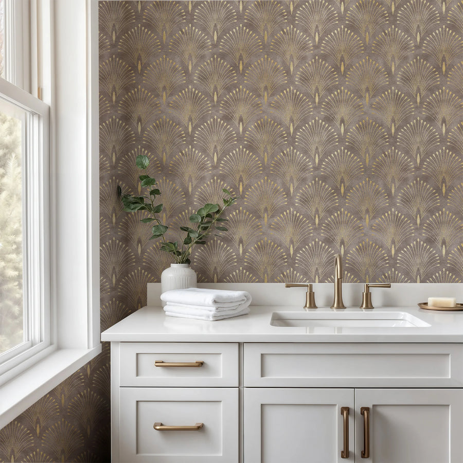 Brown and gold Art Deco fan wallpaper above a white bathroom vanity with brass hardware