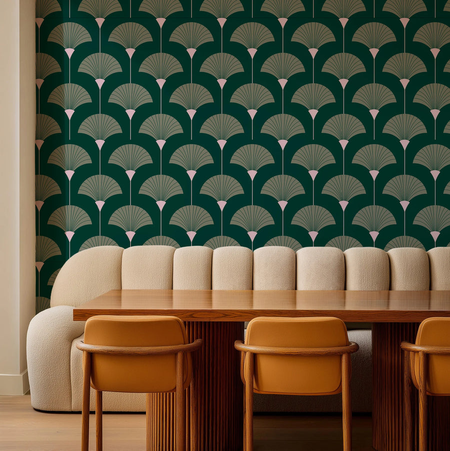 Forest and sage green Art Deco fan wallpaper behind a banquette with wood chairs