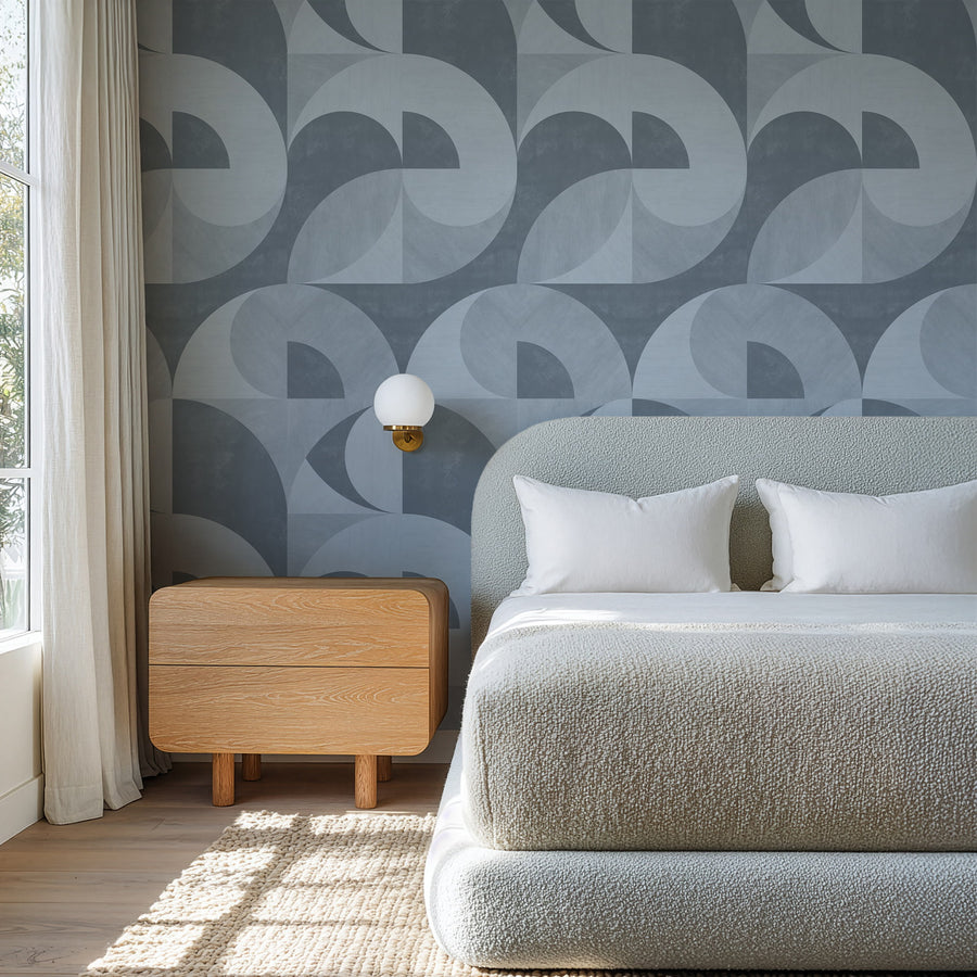 Bedroom with white bedding and wood nightstand featuring Bauhaus Geometric Circles Wallpaper Dusty Blue Grey by Petra Kohlmayr