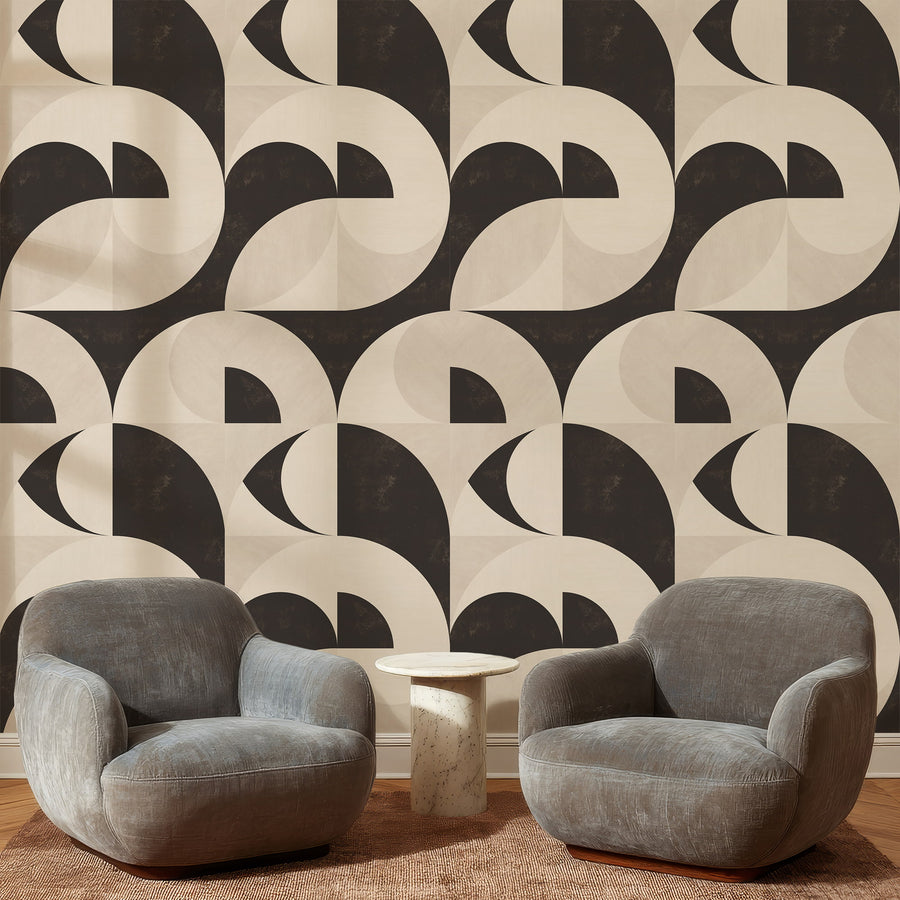 Lounge area with grey curved armchairs featuring Bauhaus Geometric Shapes Wallpaper Espresso Cream accent wall