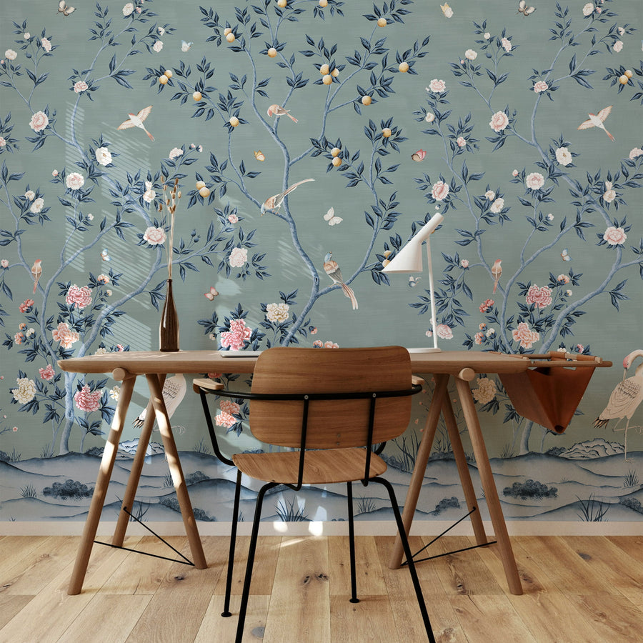 Blue chinoiserie crane wallpaper mural in a dining room behind a wood table