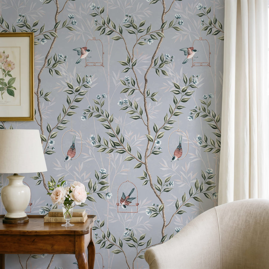 Living room with cream sofa wood console table lamp and framed art featuring Blue Chinoiserie Pauline Wallpaper Birds Branches by Maja Pitschmann