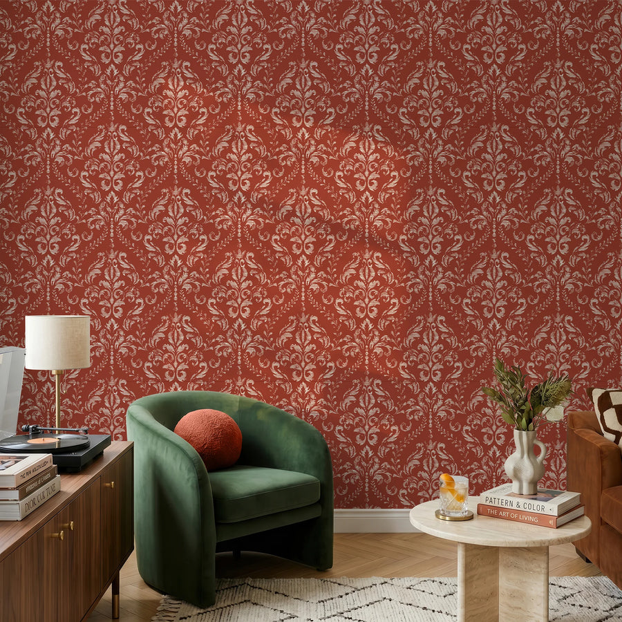 Classic red damask wallpaper in a living room with a green velvet chair