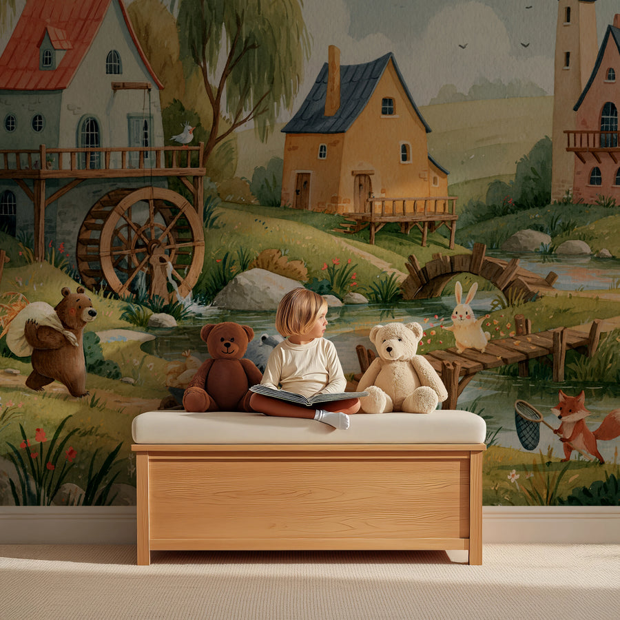Riverside countryside wall mural with a water wheel behind a child reading on a wooden toy bench