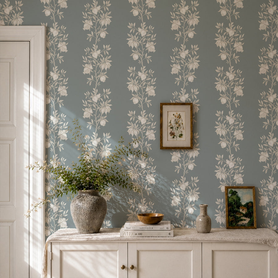 Console with vase books and framed art featuring Elodie Chinoiserie Pomegranate Wallpaper Muted Blue by Maja Pitschmann
