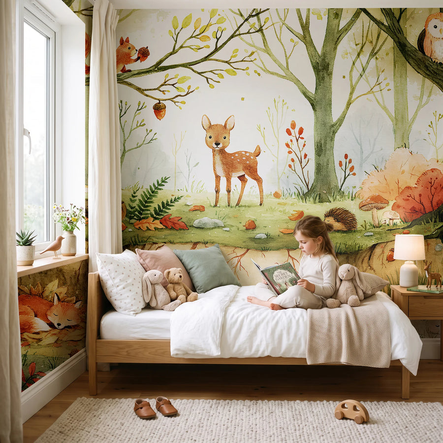 Forest animals wall mural for kids in a bedroom with a child sitting on the bed