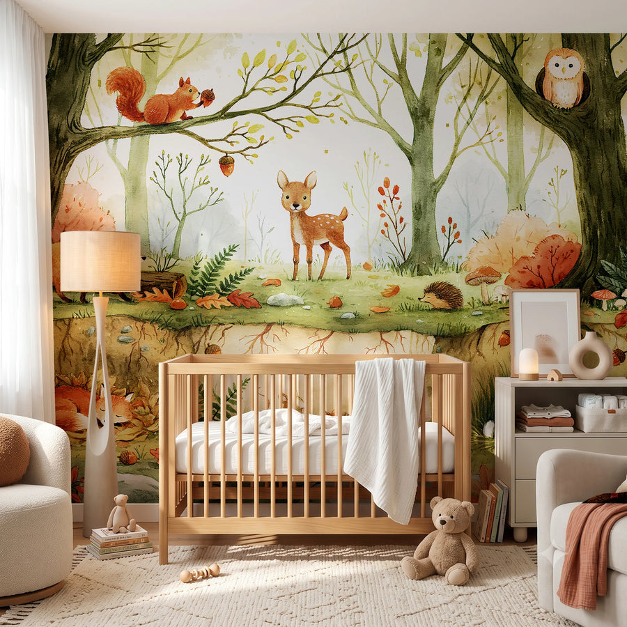 Watercolor forest animals nursery mural behind a wooden crib and armchair