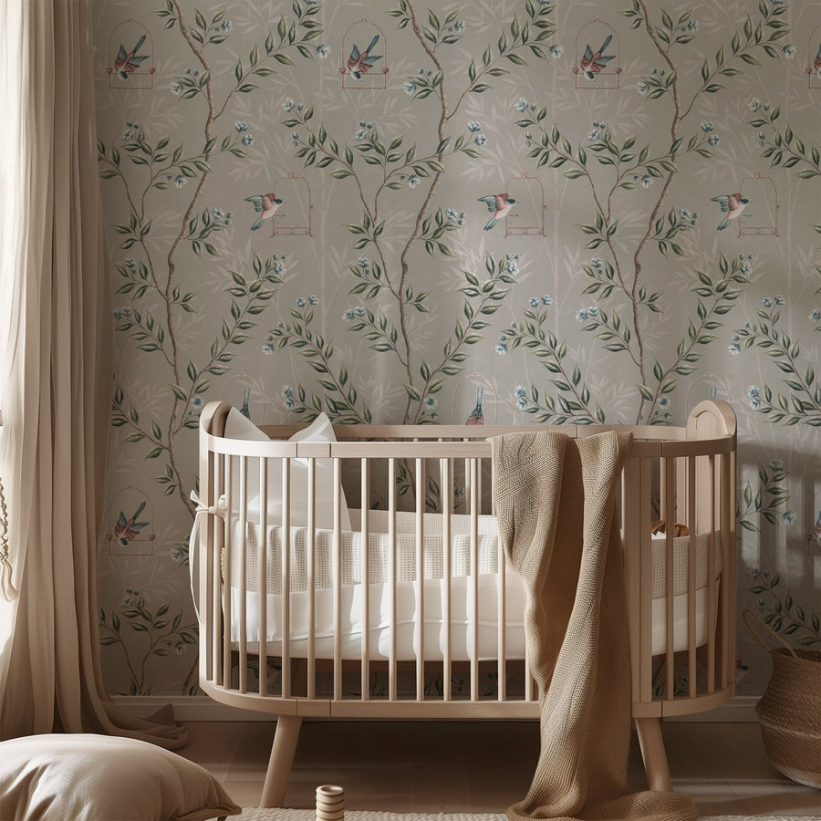 Nursery with wood crib and draped canopy featuring Gray Chinoiserie Pauline Wallpaper Birds Branches accent wall