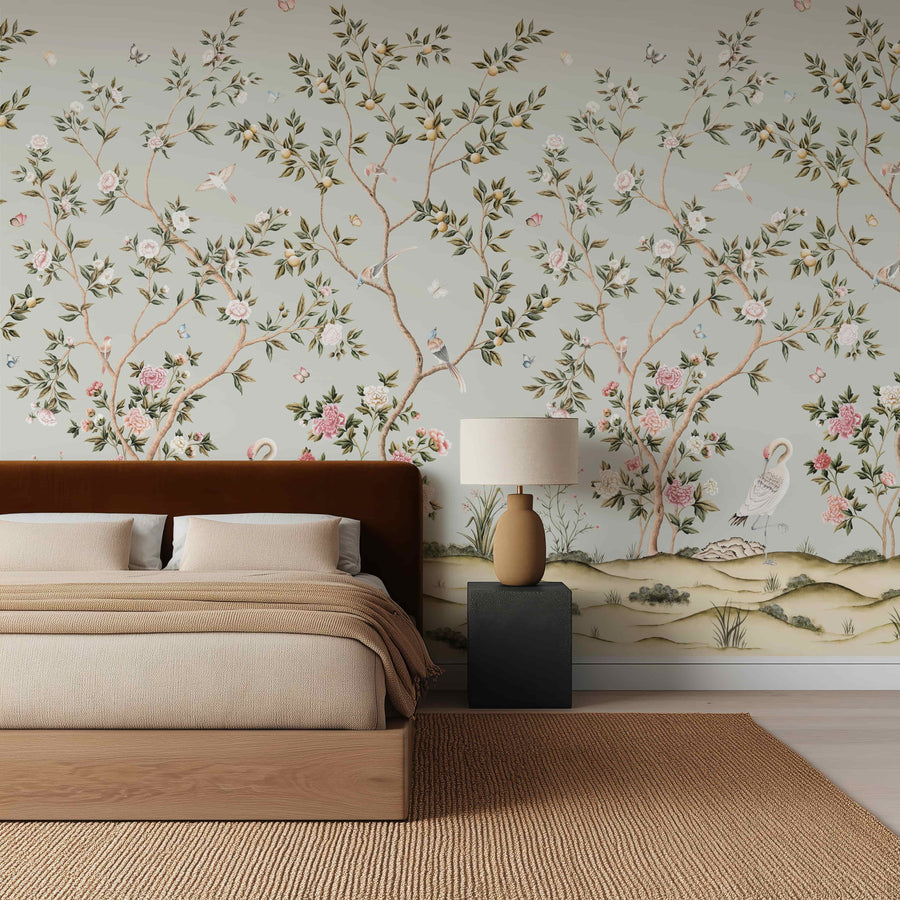 Light blue chinoiserie crane wallpaper mural in a bedroom behind a wood-framed bed