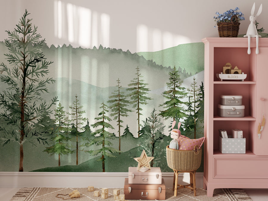 Sage green mountain wall mural beside a pink cabinet in a girl's nursery