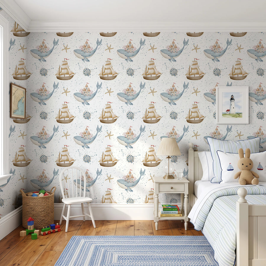 Watercolor whale and sailboat nautical wallpaper in a kids room with a blue rug and single bed