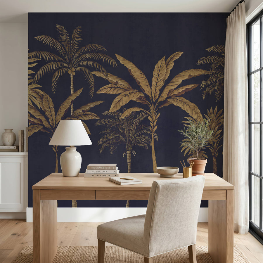 Navy and gold palm tree mural in a home office behind a wood desk and lamp