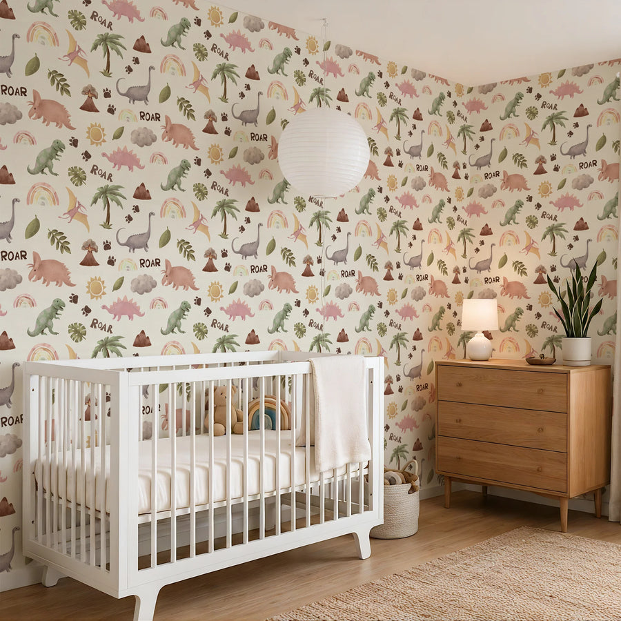 Pastel dinosaur and rainbow wallpaper wrapping a nursery corner with a white crib and paper lantern