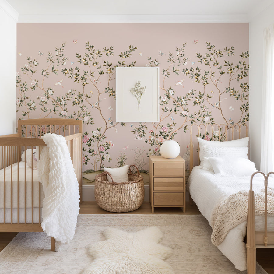 Pink chinoiserie crane mural in a nursery with crib and neutral decor