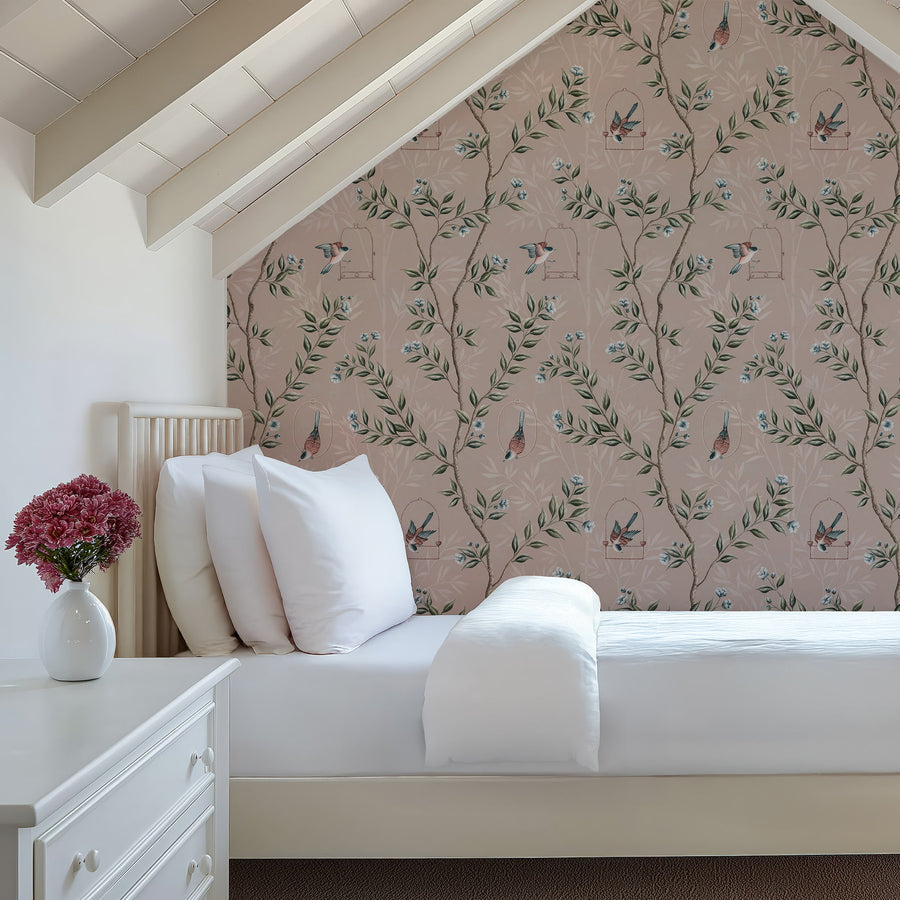 Bedroom with white bedding under a vaulted ceiling featuring Pink Chinoiserie Pauline Wallpaper Birds Branches accent wall