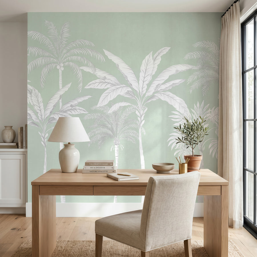 Sage green palm tree wallpaper mural behind a wood console with lamp and vase