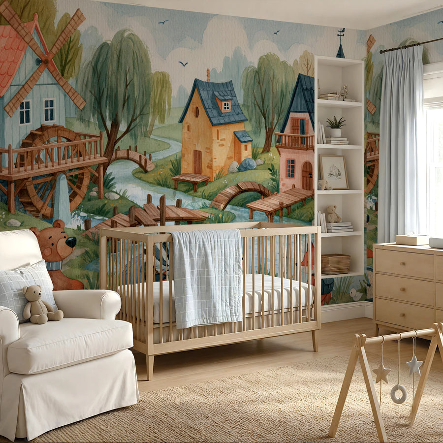 Storybook village nursery mural behind a crib and white armchair in a nursery