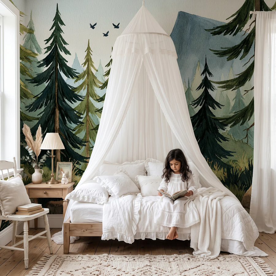 Watercolor pine forest and mountain mural behind a canopy bed with a child reading