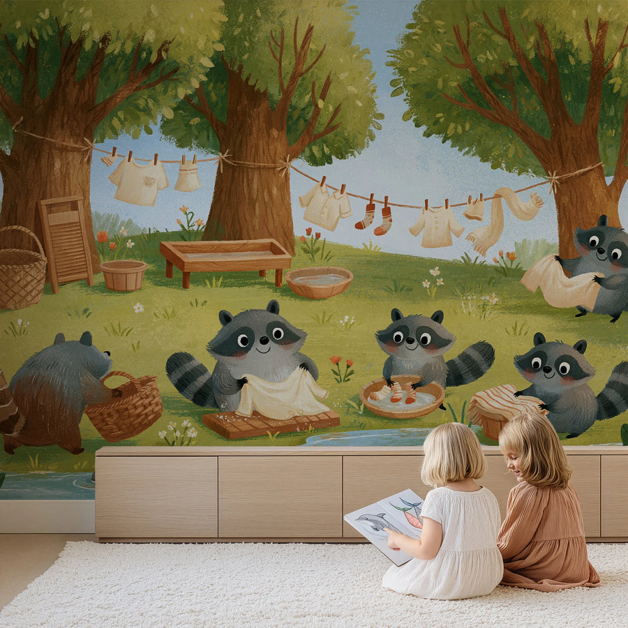 Whimsical raccoon forest wall mural for kids by Uta Naumann behind two children reading in front of a low cabinet