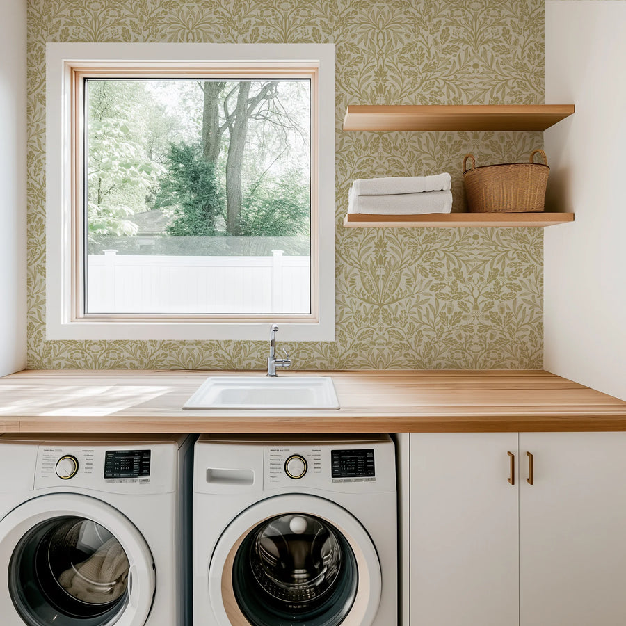 William Morris Acorn green wallpaper in a laundry room with a window and shelves