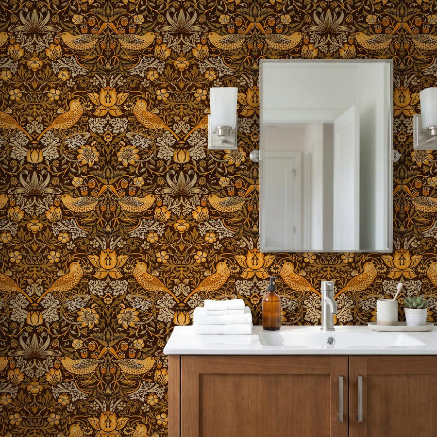 William Morris Strawberry Thief brown wallpaper in a bathroom with a wood vanity