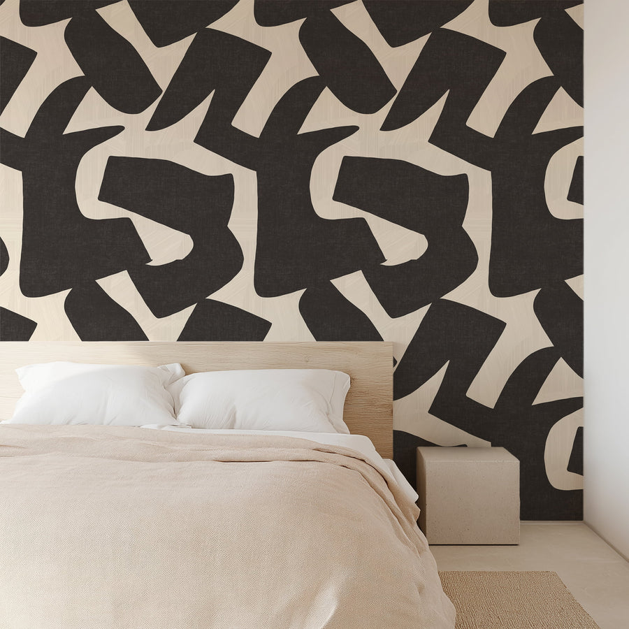 Woodland Intarsia black and cream abstract cutout wallpaper in a modern living room setting