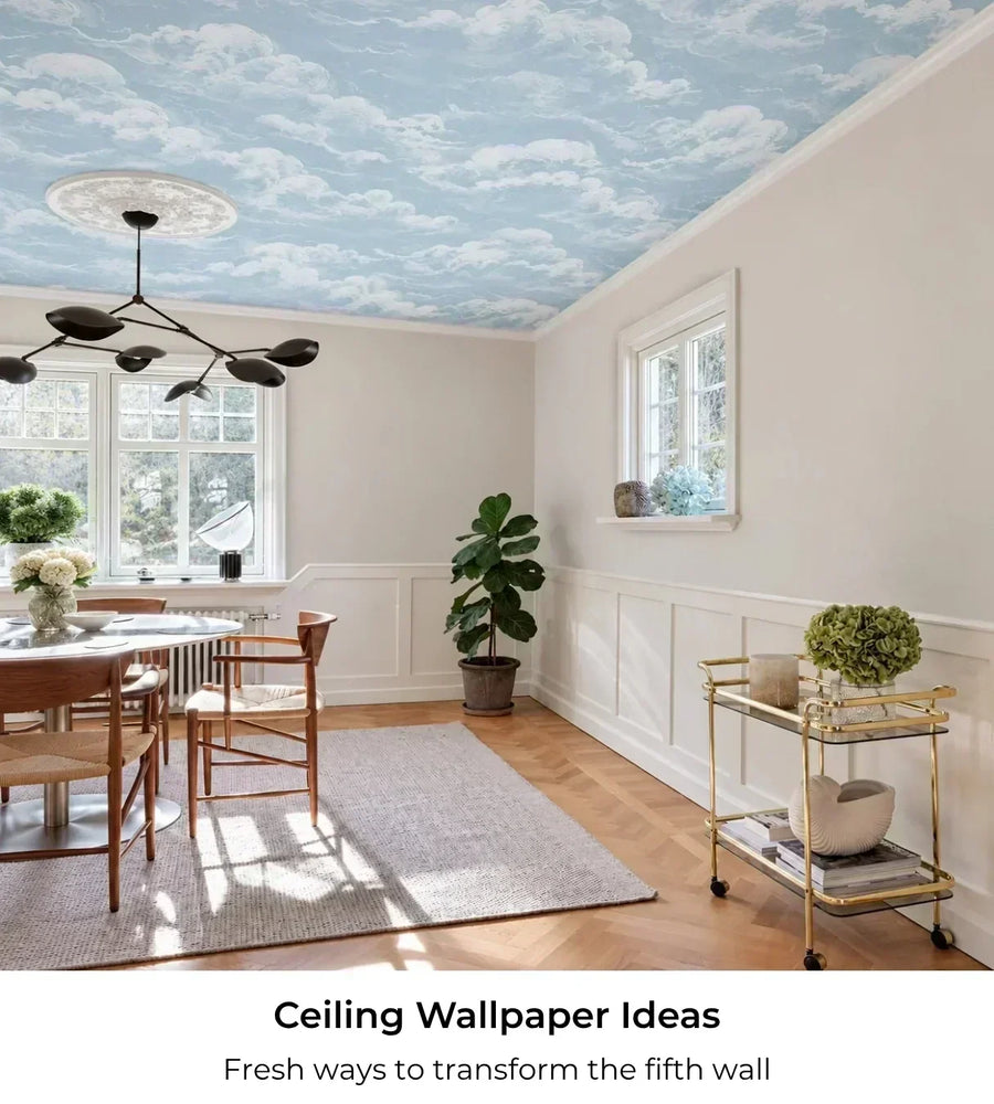 Bright dining room with blue cloud ceiling wallpaper and text reading Ceiling Wallpaper Ideas, Fresh ways to transform the fifth wall.