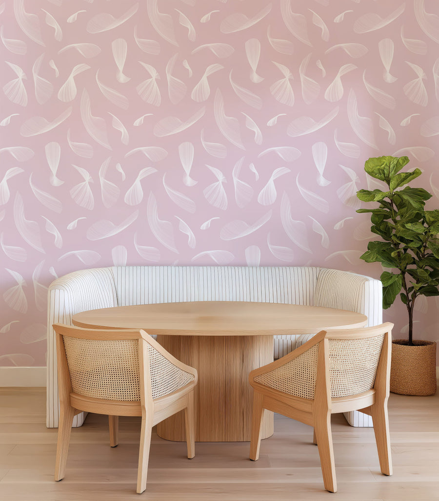 Dining area with wooden table and chairs against a Pink Quill Whispers - Modern Feather Wallpaper