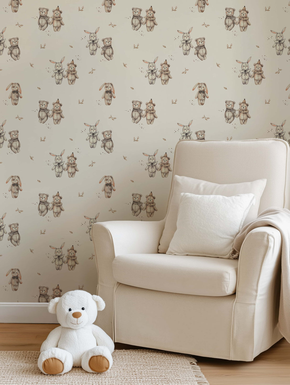 Beige armchair with white cushions and a teddy bear in front of teddy bear-patterned wallpaper.