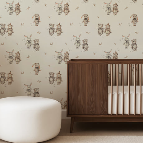 Nursery room with wooden crib, white ottoman, and teddy bear patterned wallpaper.