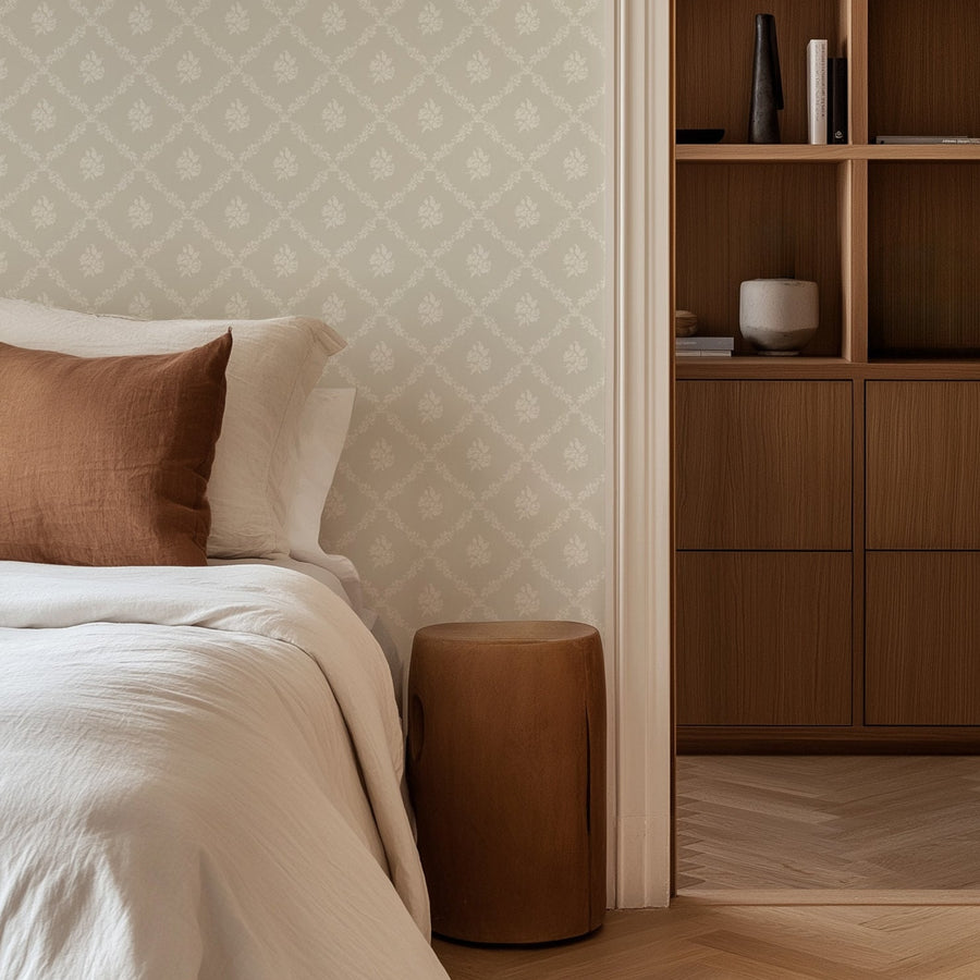 Bedroom with Della wallpaper in cream featuring a subtle white diamond floral lattice pattern on a light beige background.