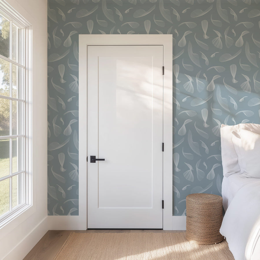 Bedroom with a white door, Quill Whispers Wallpaper – Slate Blue, and natural light from a window.