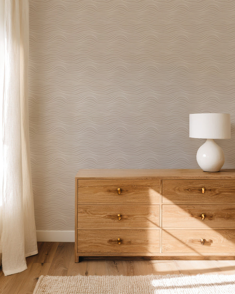 Beige minimalist wallpaper with white wavy line pattern for modern neutral interiors