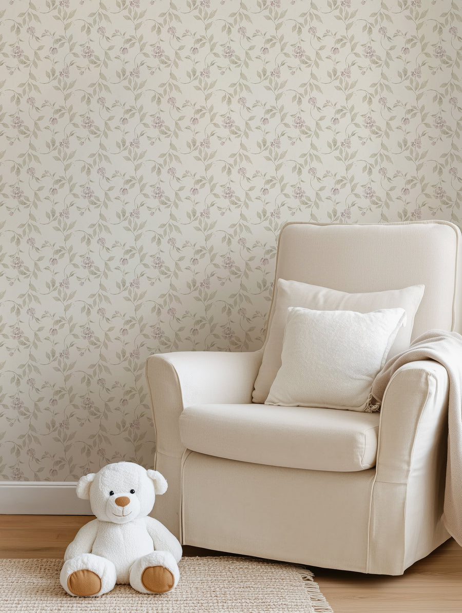 Beige armchair with white pillows and a white teddy bear on a beige carpet in a room with floral wallpaper.